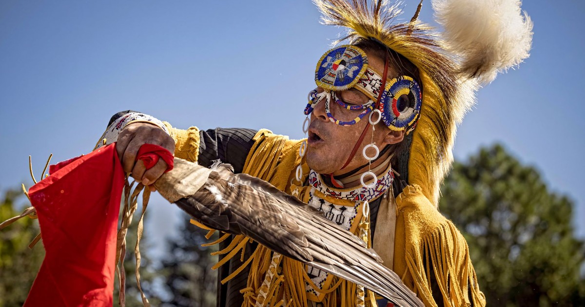 A Native American dancer in traditional attire performing outdoors in Colorado Springs.