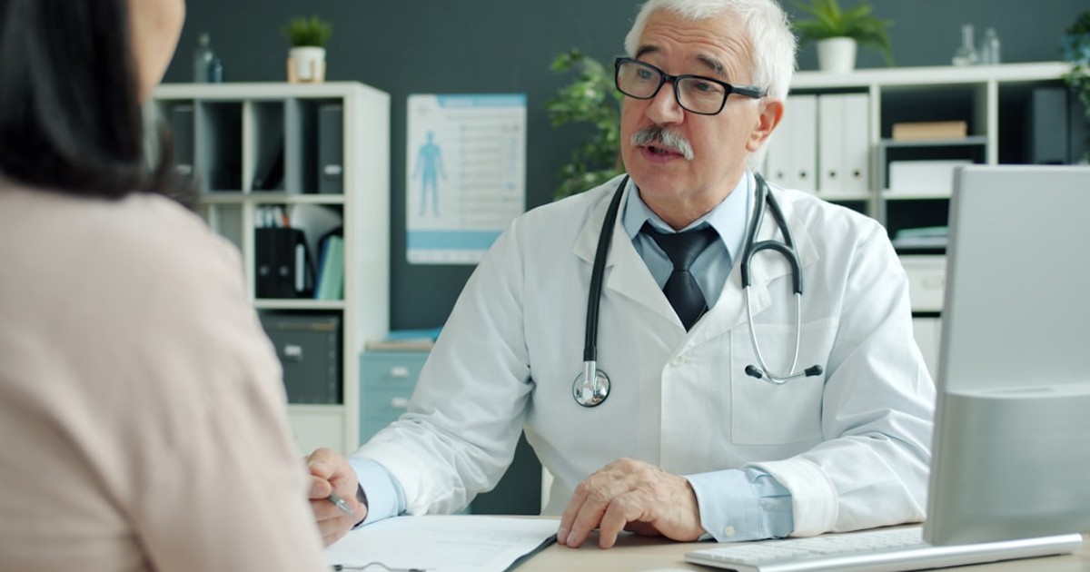 Doctor talking to patient in an office.