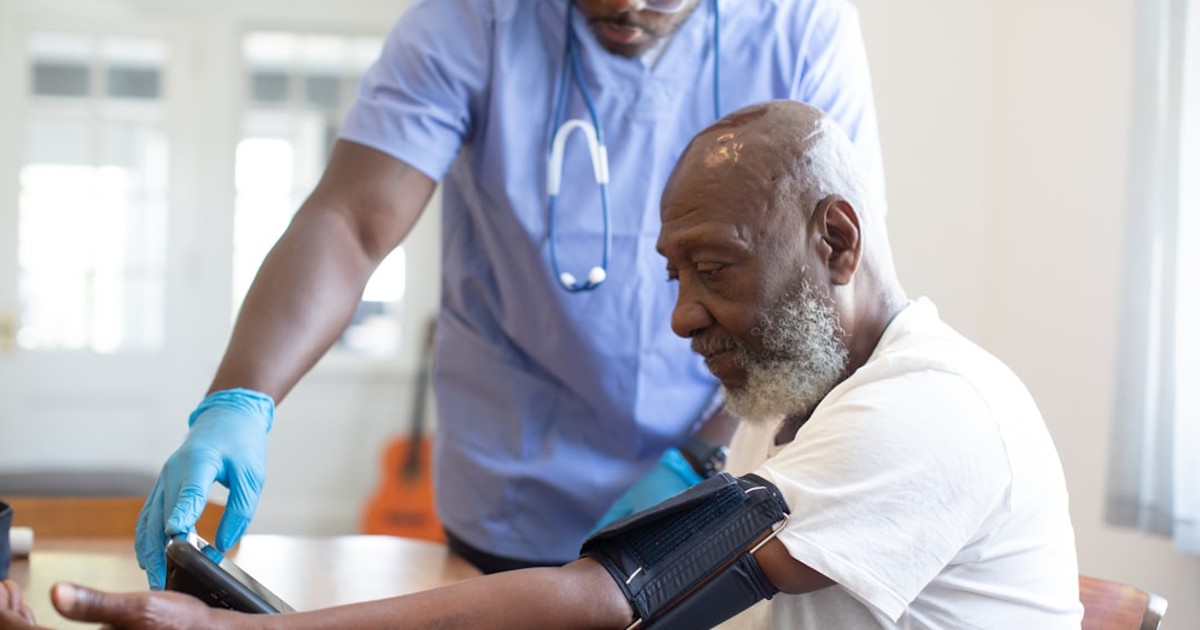 a doctor checking a patient's blood pressure