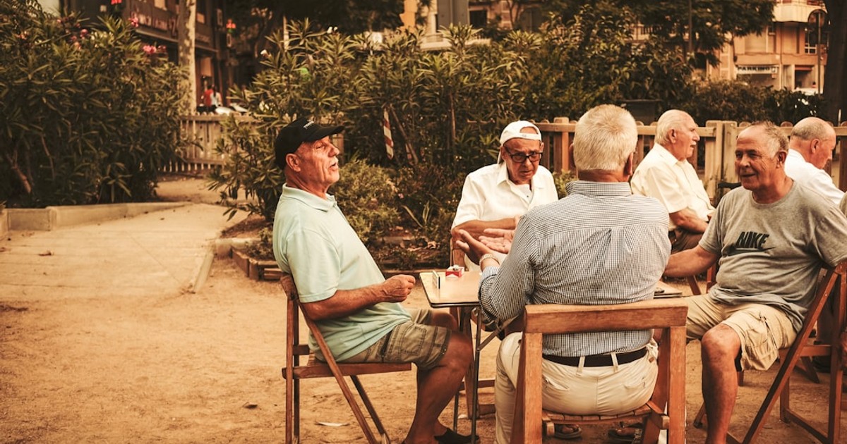 group of old men sitting near table