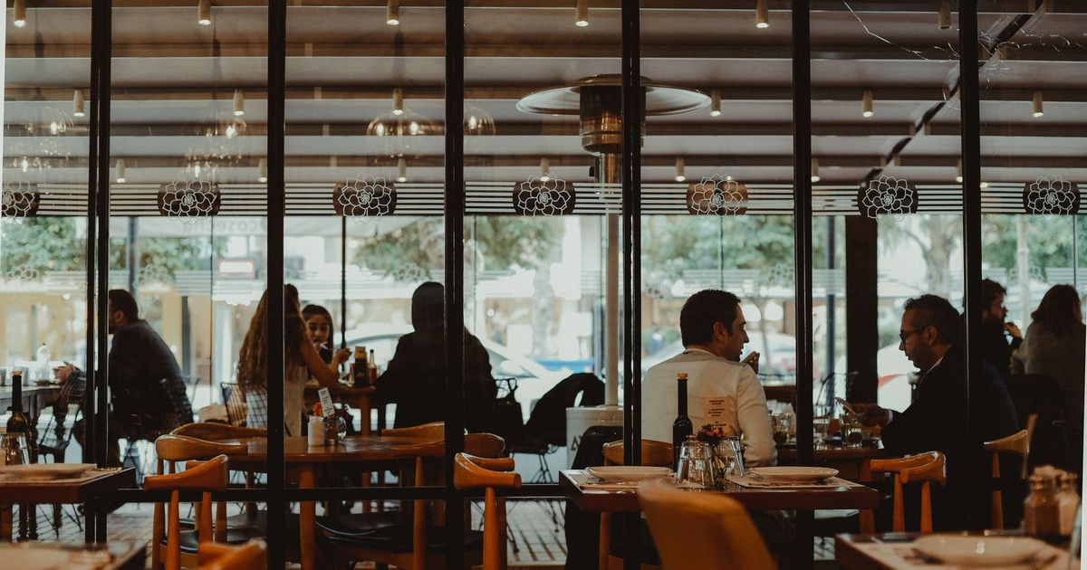 A bustling restaurant interior showcasing diners enjoying their meals in a cozy atmosphere.