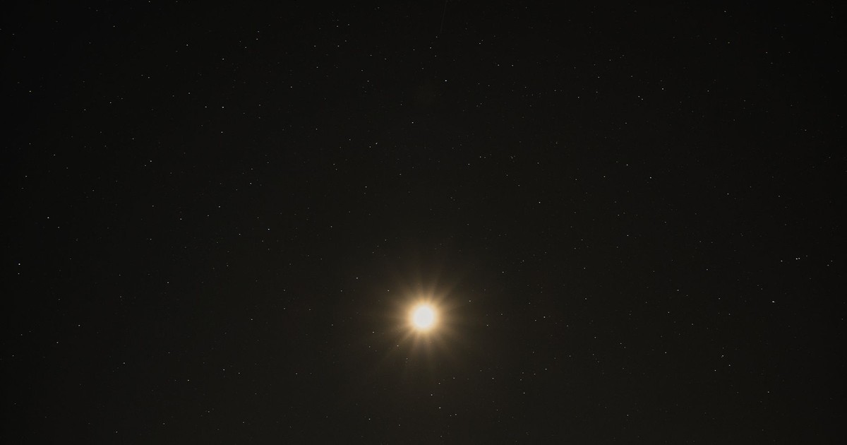 A stunning view of the bright moon surrounded by a starry sky over Poprad, Slovakia.