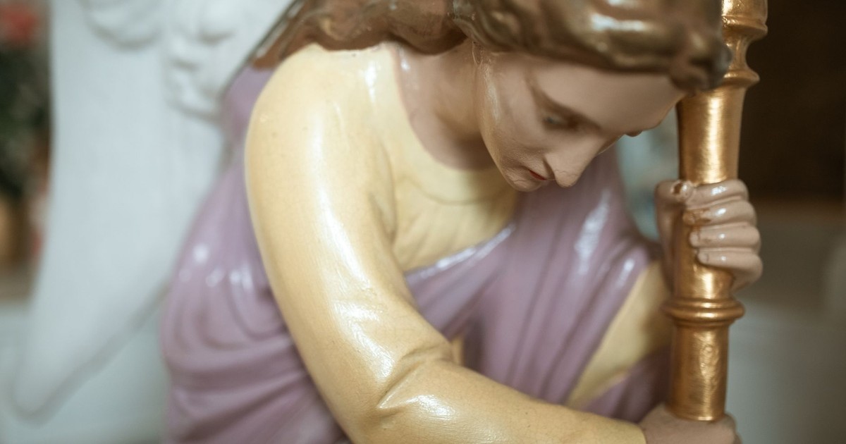 A detailed close-up of a religious angel figurine, symbolizing faith and devotion.