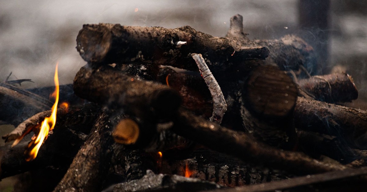 A warm and vibrant close-up view of firewood burning in a campfire, emitting heat and energy.