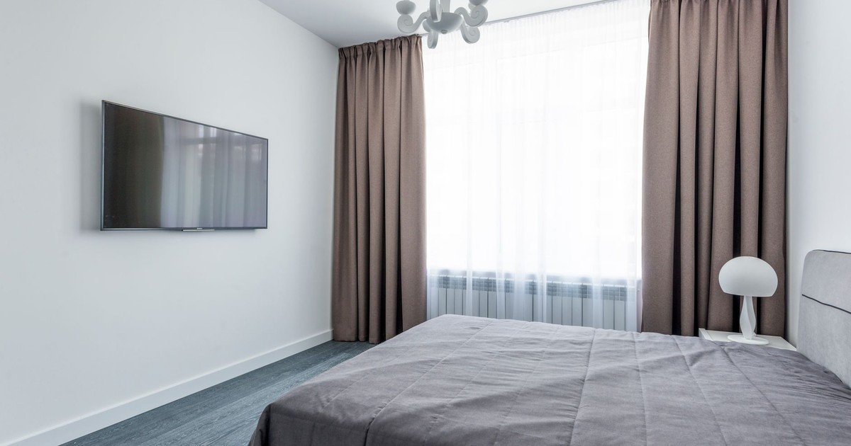 A minimalist bedroom featuring sleek furniture and a modern interior design.