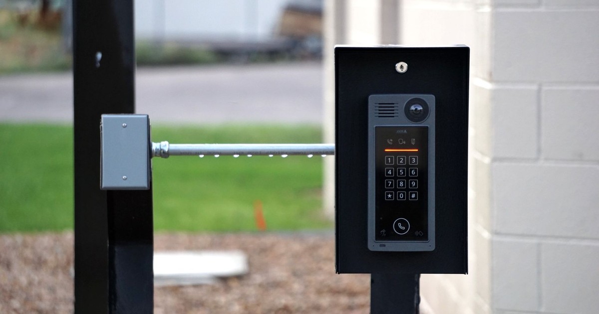 Outdoor intercom mounted at a residential building entrance, ensuring security and communication.