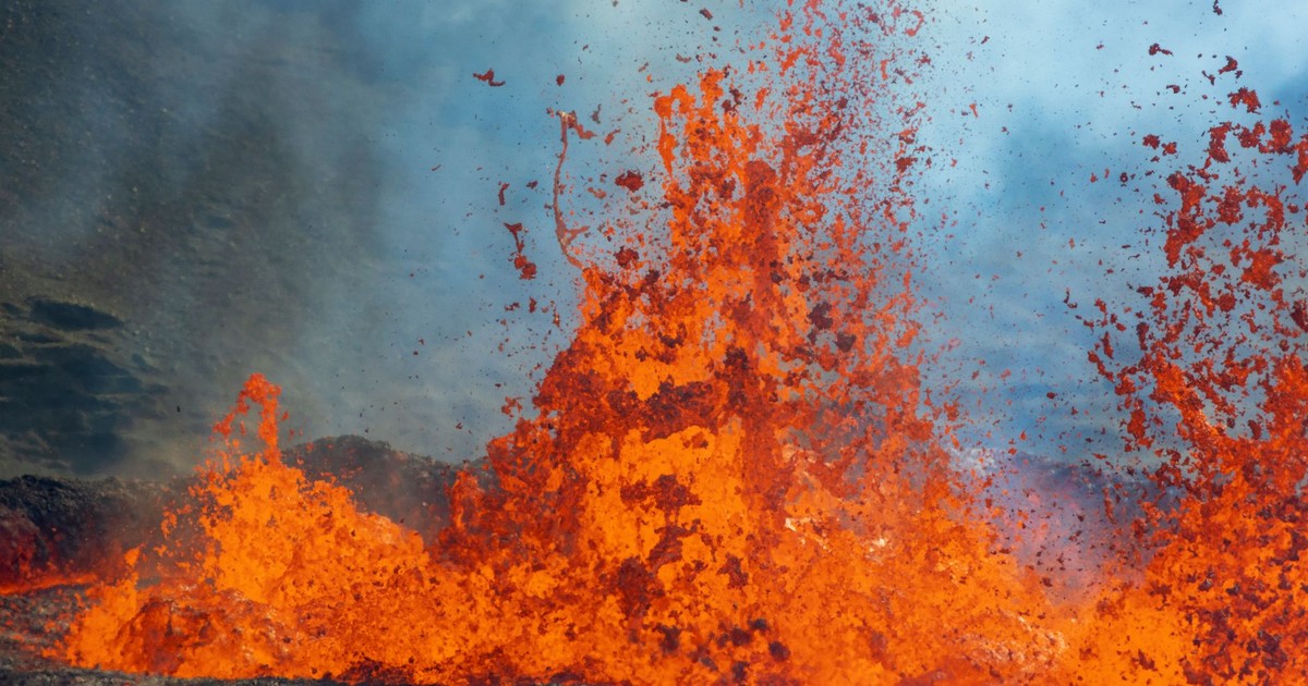 Close-up of vibrant orange lava erupting from a volcano, capturing the intensity and power of nature.