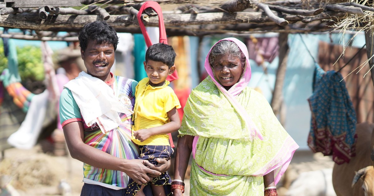 A candid portrait showcasing a happy rural Indian family outdoors.