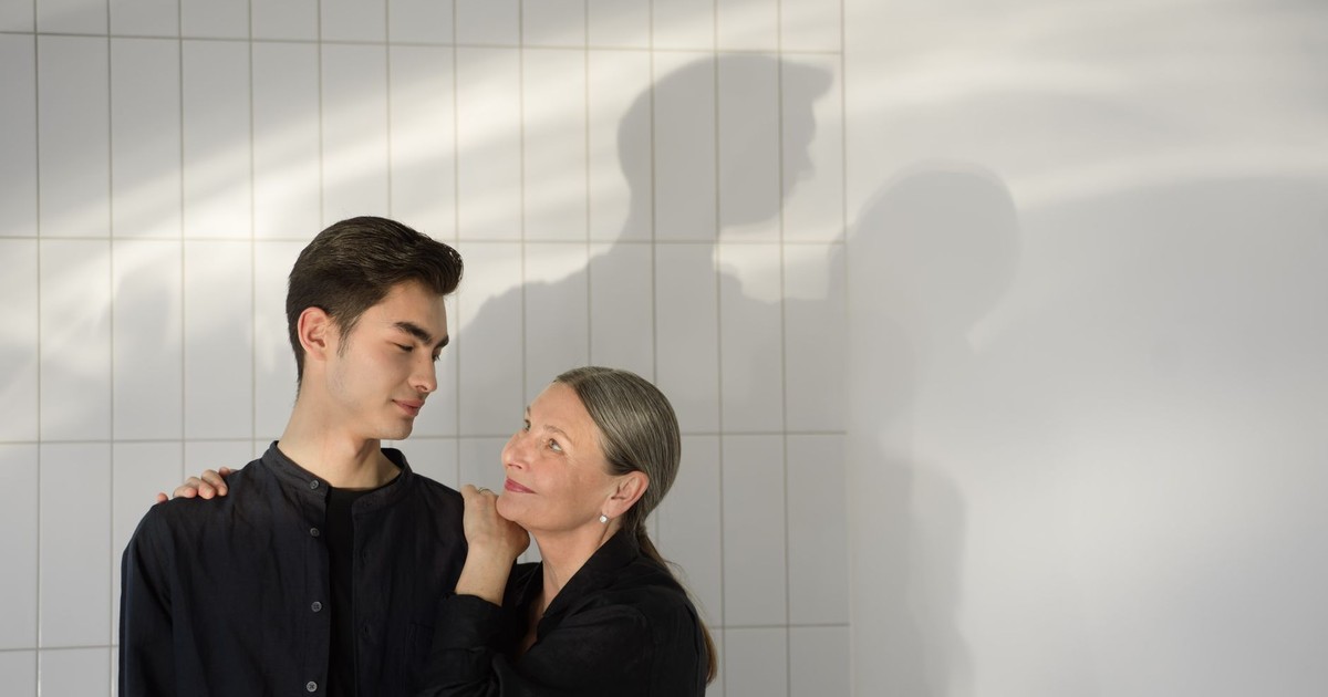 A touching moment between a mother and son in soft lighting, conveying warmth and love.