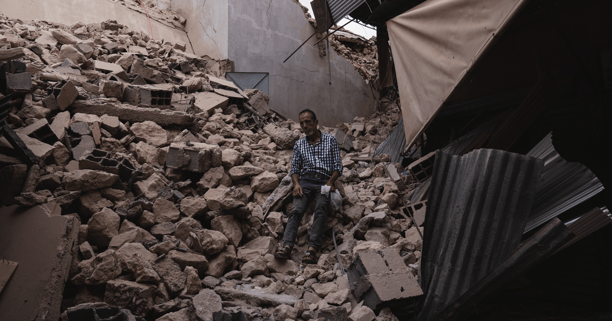 A man sits amidst collapsed buildings and debris following an earthquake in Marrakesh, Morocco.