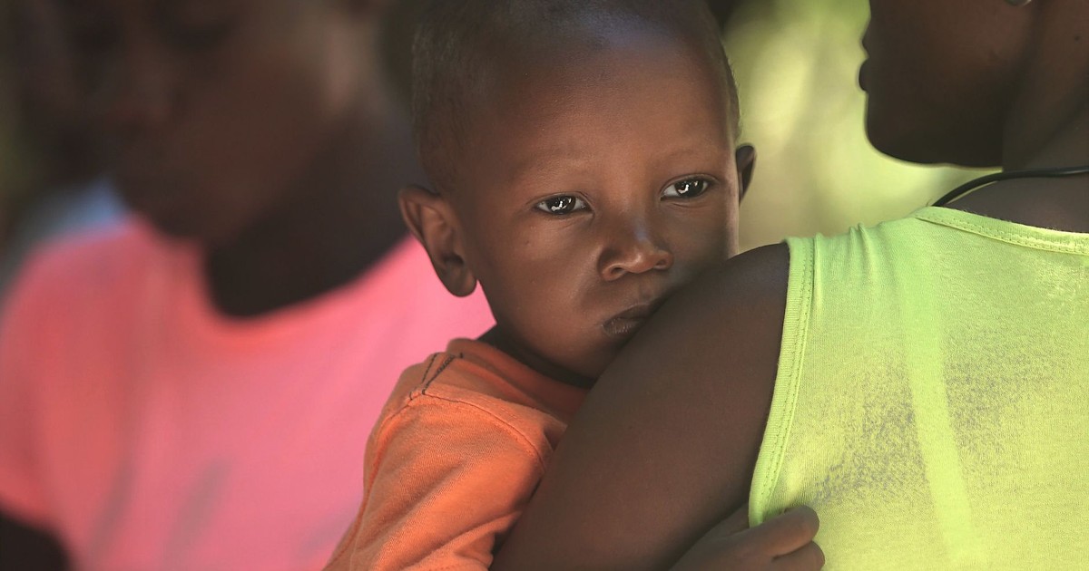 Close-up of a mother carrying her son, capturing a tender moment in Haiti.