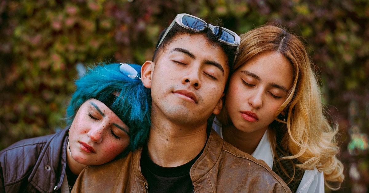 A peaceful portrait featuring three friends resting close together against a leafy backdrop, embodying tranquility and companionship.