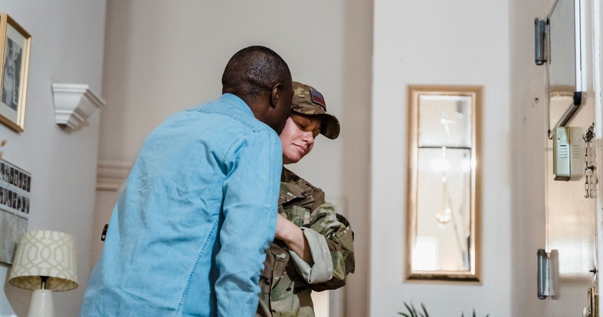 A touching moment as a soldier is warmly embraced by their partner at home.