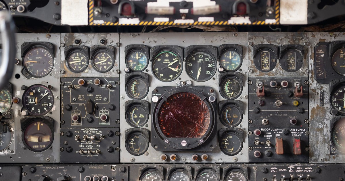 Close-up of a vintage aircraft cockpit control panel showcasing various dials and gauges.