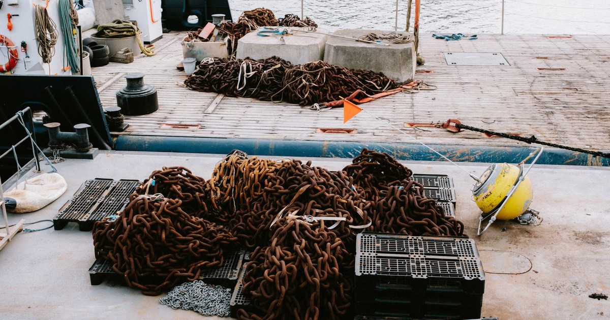 A detailed view of chains and equipment on a ship deck, perfect for maritime industry and travel themes.