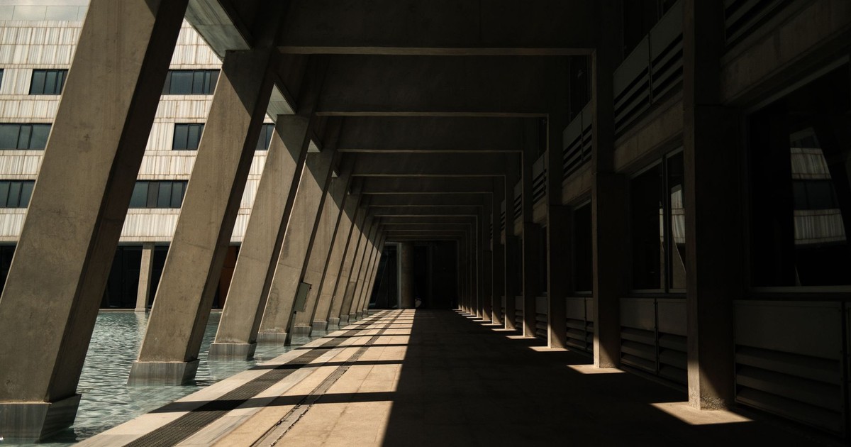 Empty modern architectural corridor in Ankara, Türkiye with striking shadows.