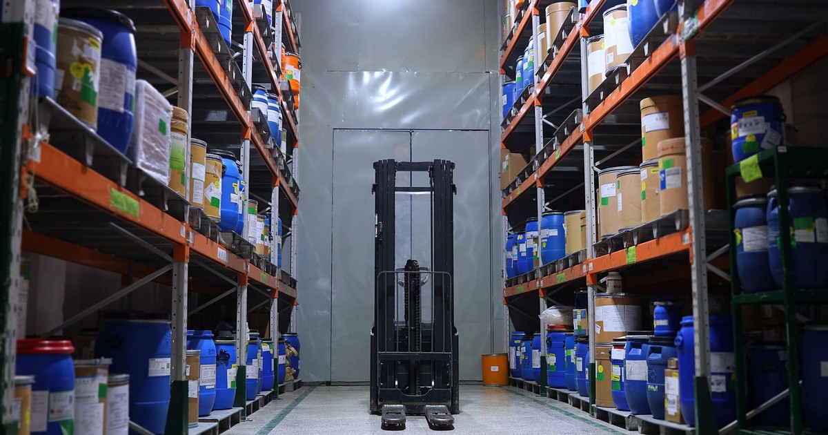 A well-organized pharmaceutical warehouse with shelves and a forklift in Islamabad, Pakistan.