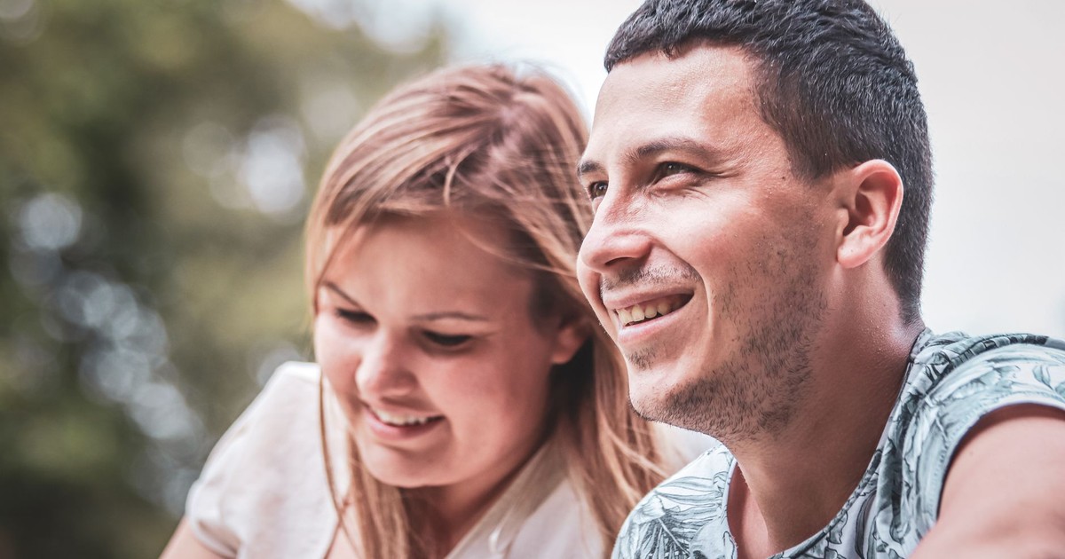 Happy couple enjoying a sunny day outdoors, captured in a candid moment of togetherness and joy.