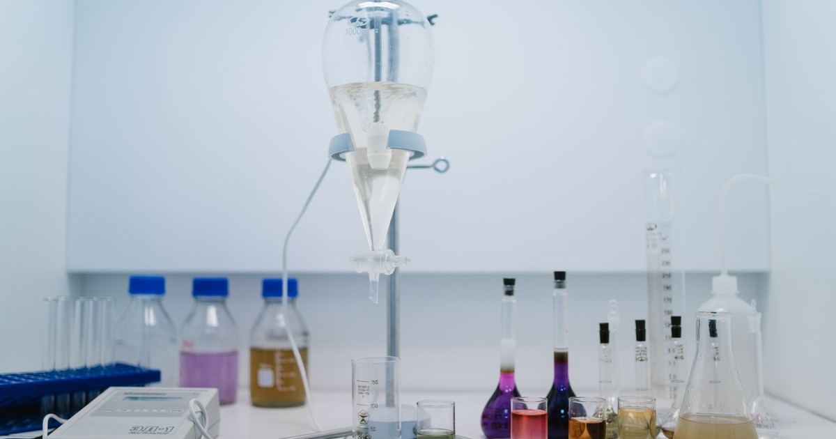 A detailed view of laboratory glassware with colorful chemicals, ideal for scientific research and experiments.