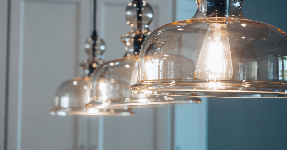 Close-up of stylish glass pendant lamps illuminating a modern indoor space.