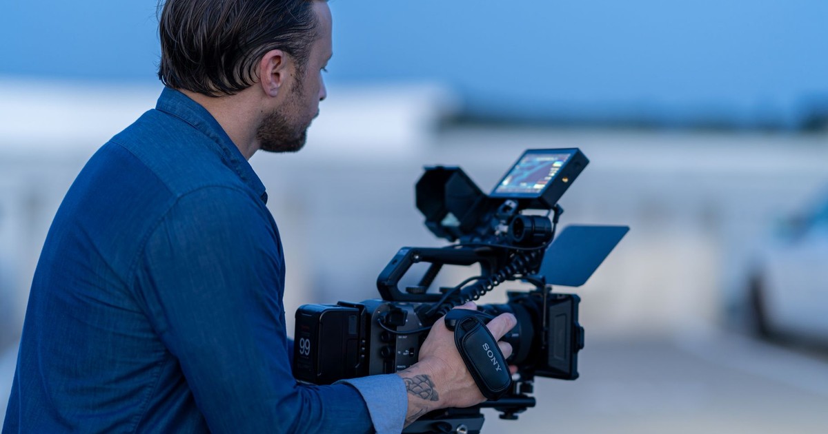 Cinematographer operating a camera during blue hour in Chicago, capturing scenic moments.