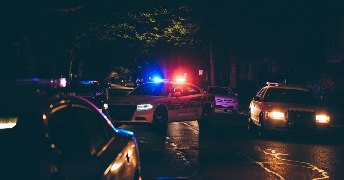 A couple of police cars parked in a parking lot