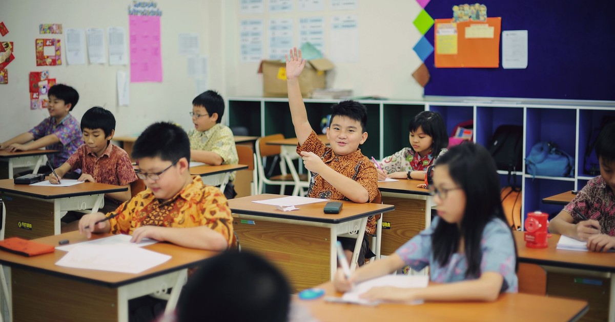 Students actively participating in a classroom environment, showcasing an engaging learning experience.