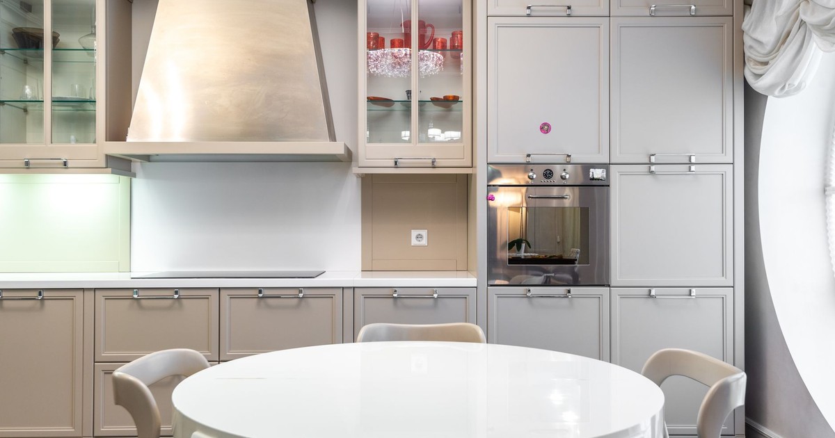 Contemporary kitchen with sleek cabinets and a round dining table.