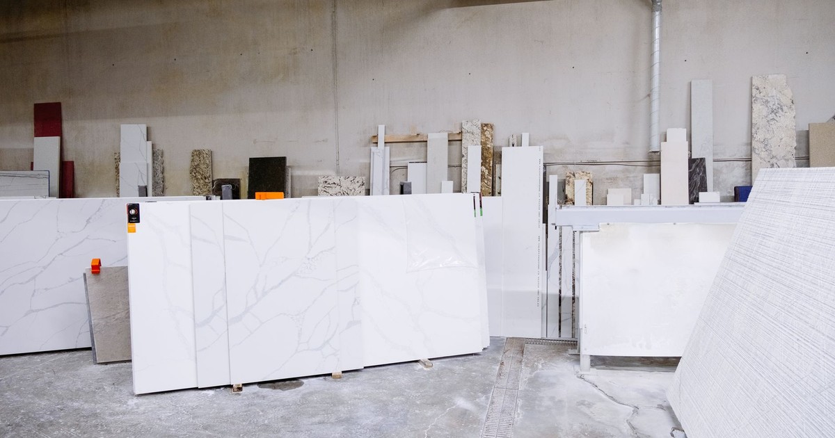 Granite and stone slabs in a manufacturing facility showing industrial processes.