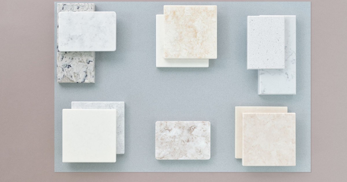 Flat lay image of various marble tile samples arranged on a neutral surface, perfect for design projects.