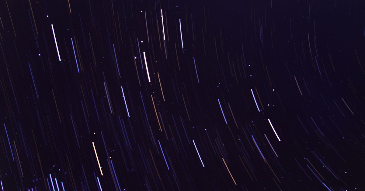 Stunning long exposure image capturing vivid star trails against a deep night sky, showcasing celestial movement.