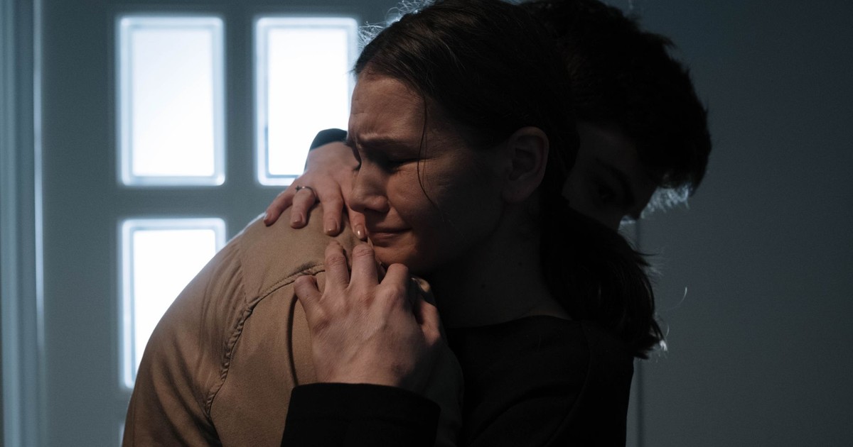 A comforting embrace between two people expressing vulnerability and support.
