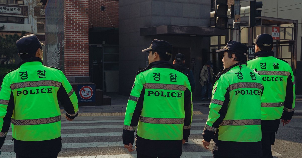 Police officers on duty in Seoul, South Korea, showcasing urban life and safety enforcement.
