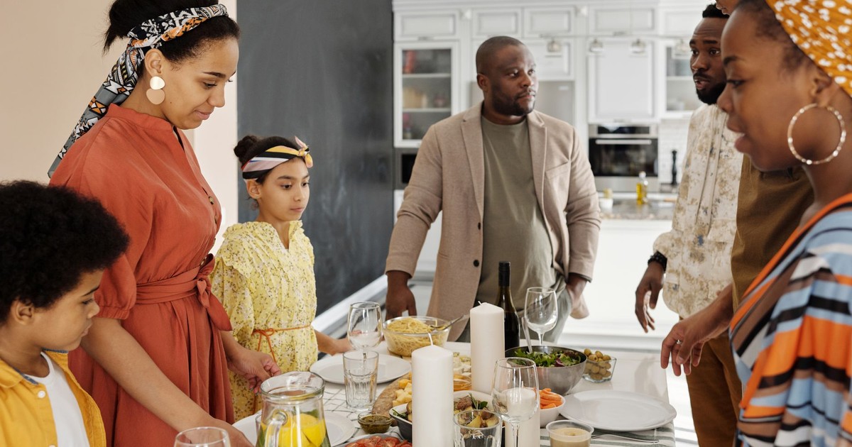 A warm family gathering around the table for a meal, sharing joy and togetherness.