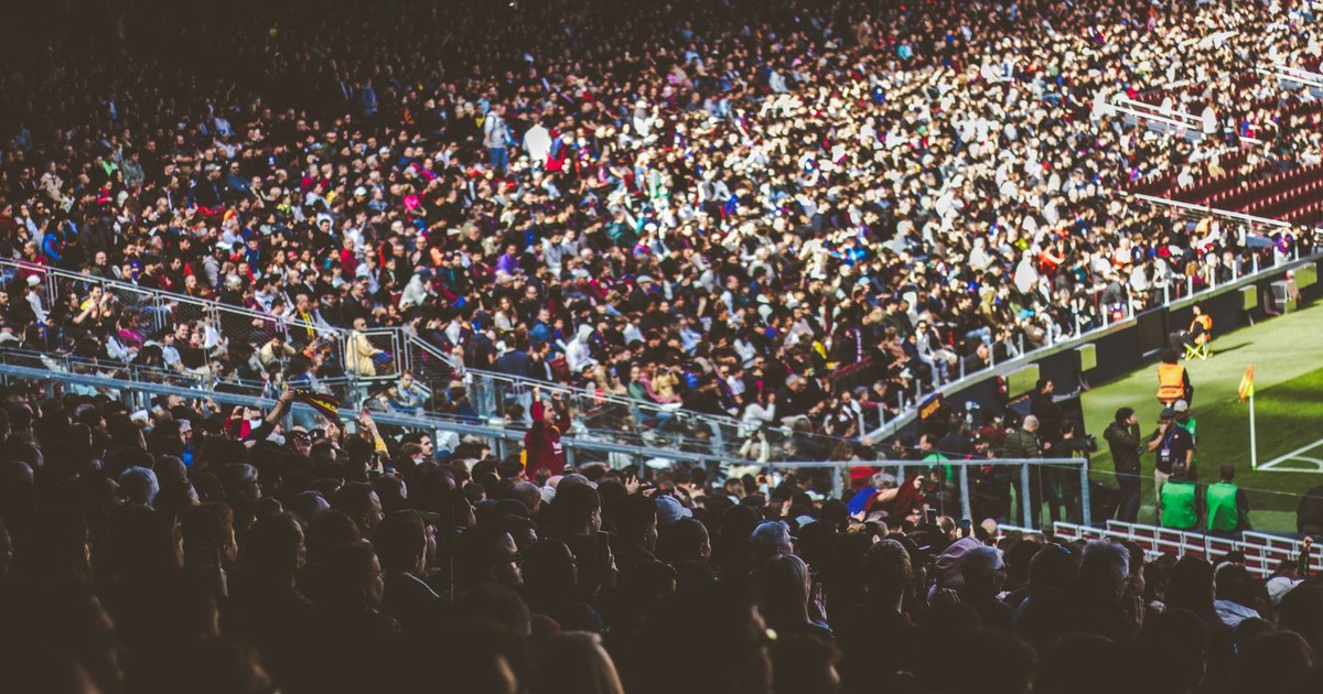 A crowded soccer stadium packed with enthusiastic fans during a match.