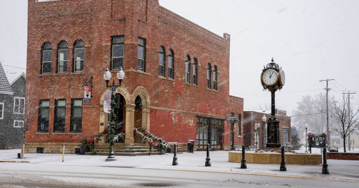 A historic brick building in Wabasha, Minnesota during a winter snowfall, showcasing vintage architecture.