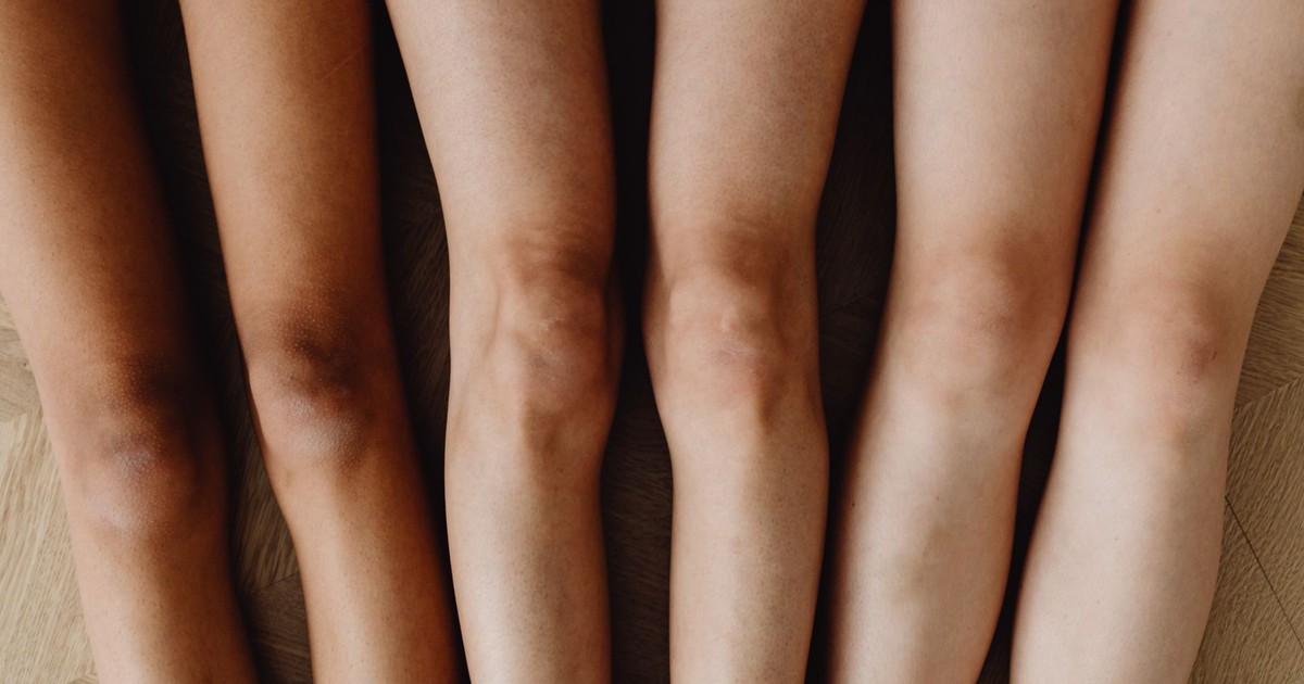Close-up of diverse human legs highlighting body diversity. Top view arrangement.