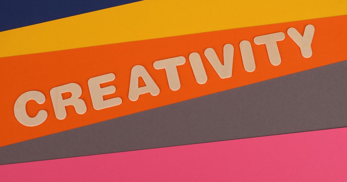 Vibrant layered paper design featuring the word 'Creativity' in bold letters.