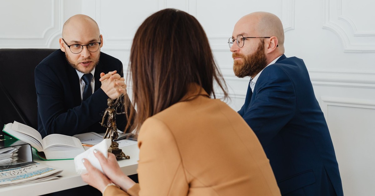 Professional discussion among lawyers in a modern office, focusing on legal matters.