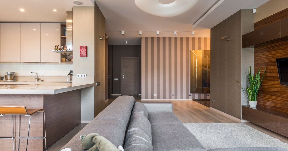 Spacious living room with a modern, minimalist design and open kitchen layout.