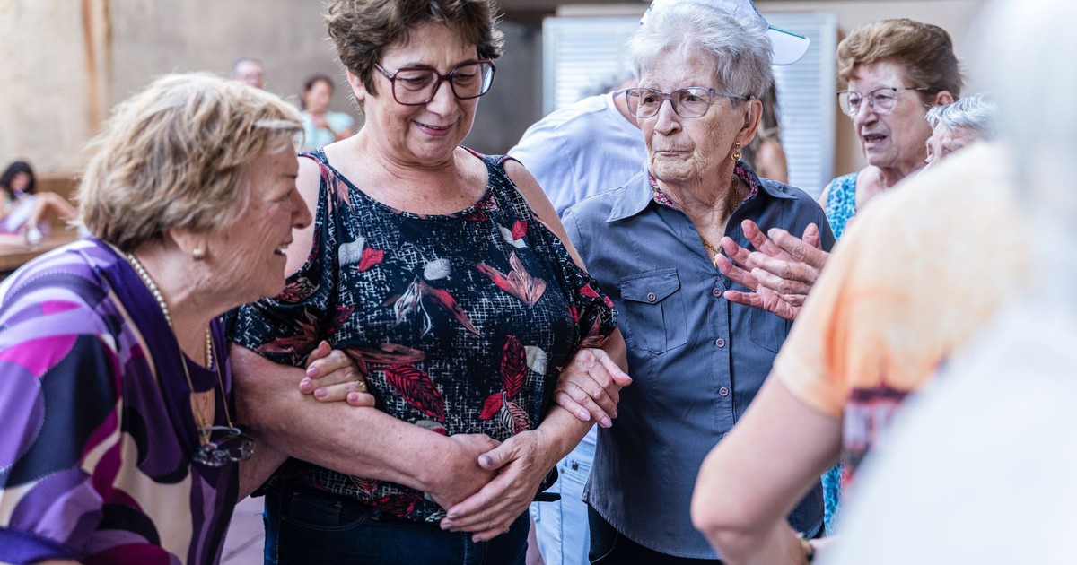 Elderly women enjoying a joyful indoor gathering, sharing smiles and companionship.