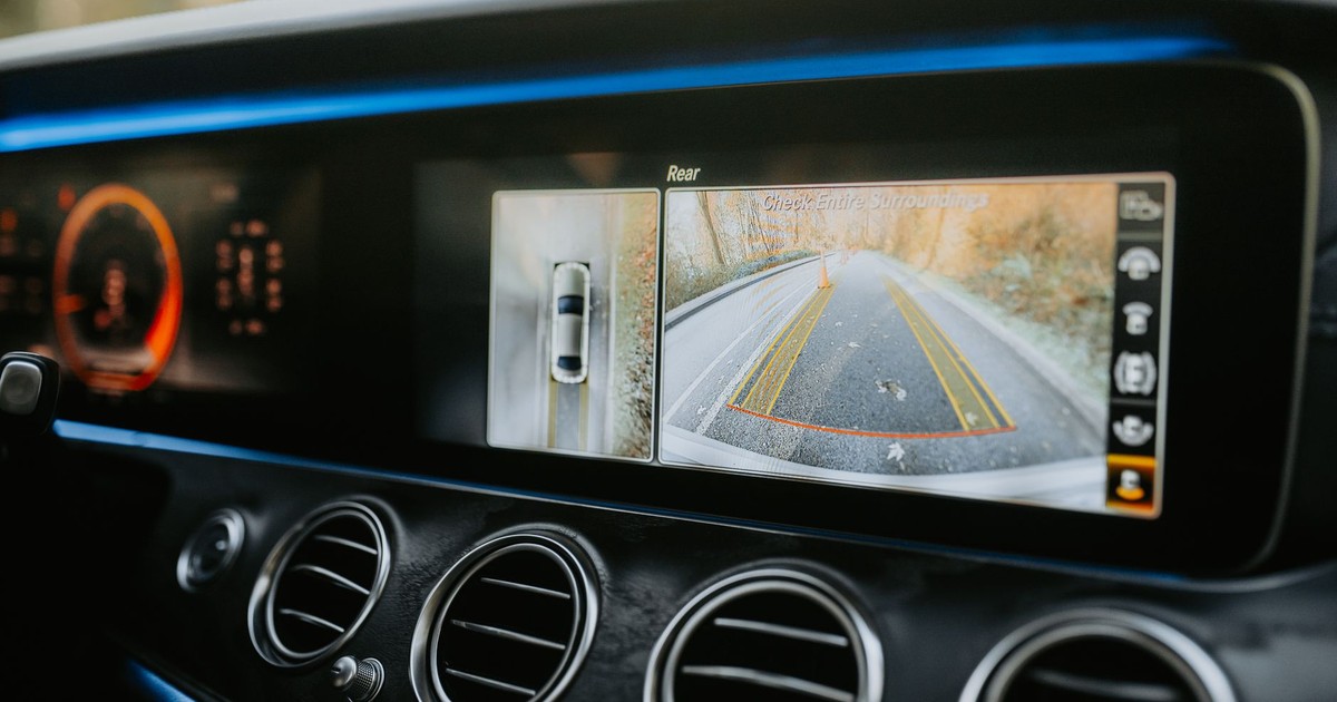 Close-up of a car dashboard showcasing a rear-view camera display and modern electronics.