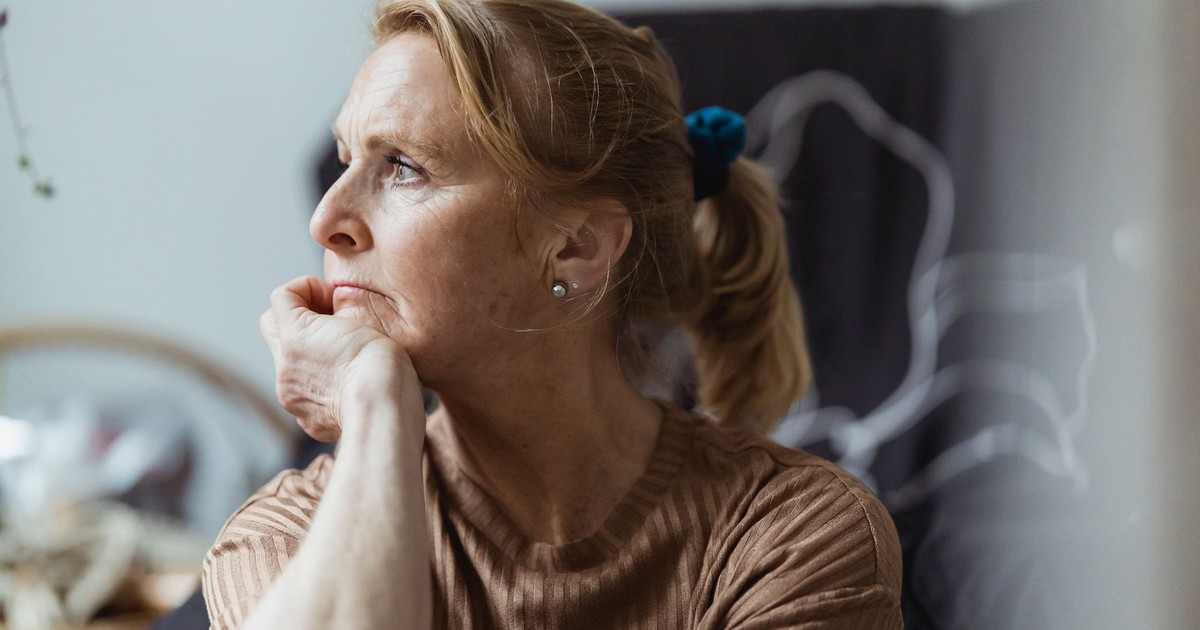 Senior woman with a thoughtful expression looking away in an indoor setting.