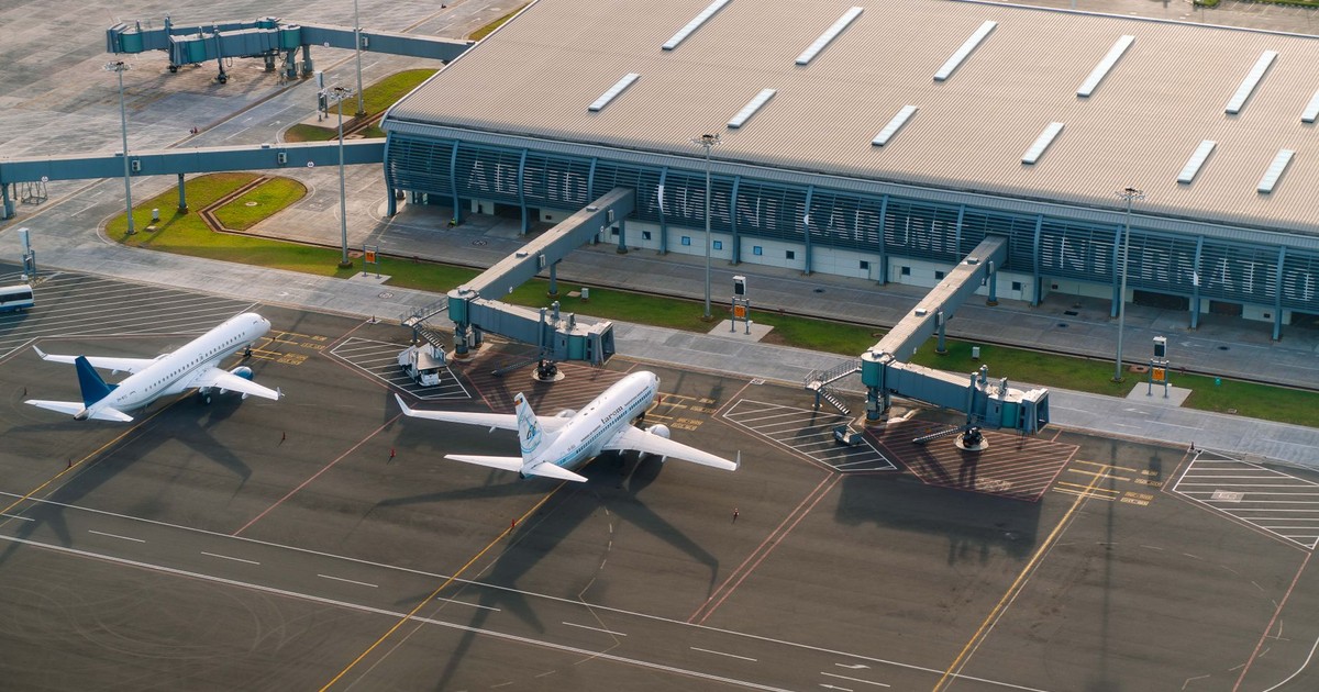 Aerial view of Abeid Amani Karume International Airport in Zanzibar, showing parked airplanes and terminal.