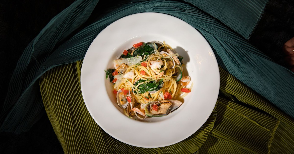 A vibrant seafood pasta dish with fresh vegetables, perfect for gourmet cuisine advertising.