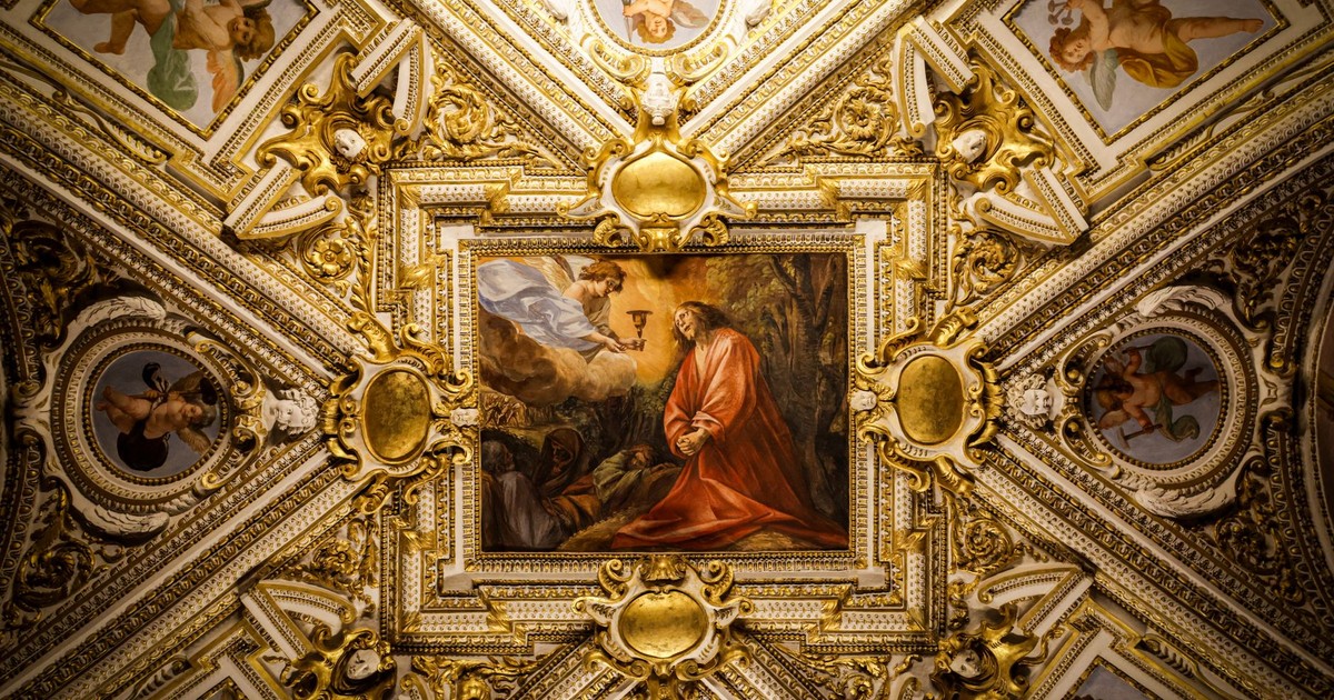 Intricately decorated Baroque ceiling featuring classical art and cherub motifs.