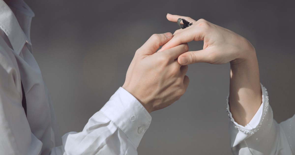 Close-up of a romantic proposal with a couple exchanging an engagement ring. Intimate and special moment.