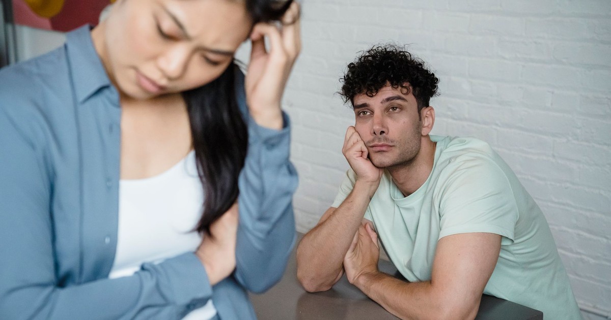 A man and woman deep in thought facing relationship tension, visible emotions in an indoor setting.
