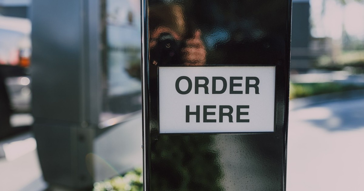 Close-up of an order sign at a drive-thru station, ideal for business contexts.