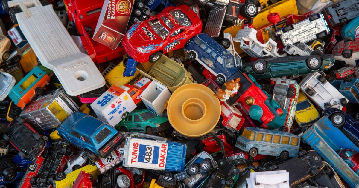 A vibrant collection of assorted plastic toy cars piled together.